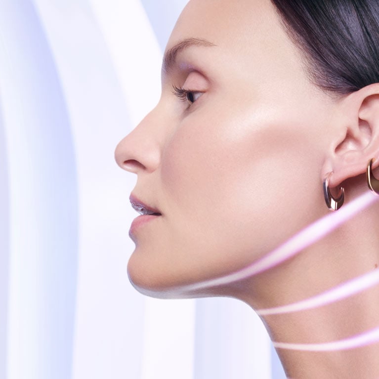Profile of a Caucasian woman’s face with strips of light to highlight her lower face and neck 